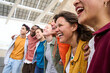 © CarlosBarquero - Photo of multiracial group of students smiling carefree outdoors. Happy young people having fun strolling along city street. Friendship concept with boys and girls enjoying leisure time.