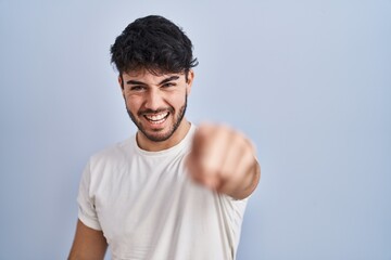 Sticker - Hispanic man with beard standing over white background pointing displeased and frustrated to the camera, angry and furious with you