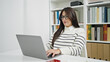 © Krakenimages.com - Young beautiful hispanic woman student using laptop with serious expression at library university