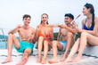 © chokniti - happy man in swimwear and woman in bikini having laugh fun in summer trip with friends group by eat bar-b-q grill and wine party drink, friendship vacation travel on sailboat yacht at the ocean sea