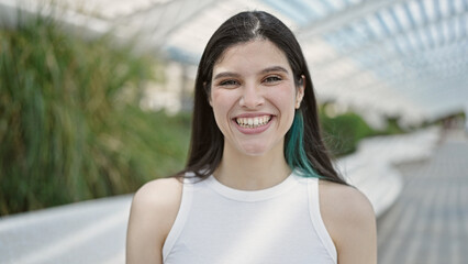 Wall Mural - Young beautiful hispanic woman smiling confident standing at park