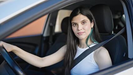 Wall Mural - Young beautiful hispanic woman driving car at street