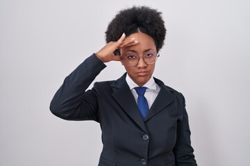 Poster - Beautiful african woman with curly hair wearing business jacket and glasses worried and stressed about a problem with hand on forehead, nervous and anxious for crisis