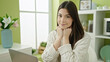 © Krakenimages.com - Young beautiful hispanic woman using laptop sitting on table at home