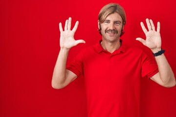 Poster - Caucasian man with mustache standing over red background showing and pointing up with fingers number ten while smiling confident and happy.