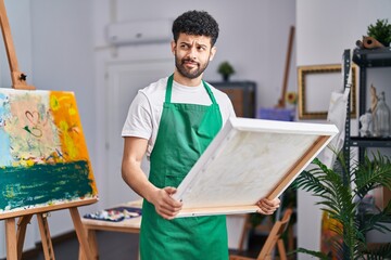 Poster - Arab man at art studio smiling looking to the side and staring away thinking.