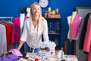 Sticker - Young blonde woman tailor smiling confident standing at sewing studio