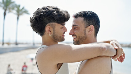 Wall Mural - Two men couple smiling confident hugging each other at seaside