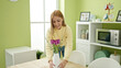 © Krakenimages.com - Young blonde woman smiling confident decorating with flowers at home