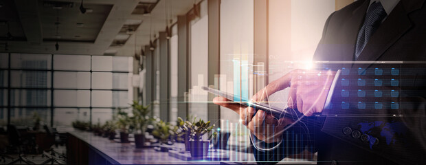 Wall Mural - businessman using tablet analyzing sales data and economic growth graph chart. business investment s