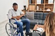 © Krakenimages.com - African american man doing therapy sitting on wheelchair with hand on stomach because nausea, painful disease feeling unwell. ache concept.