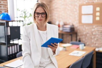 Poster - Young caucasian woman working at the office wearing glasses skeptic and nervous, frowning upset because of problem. negative person.