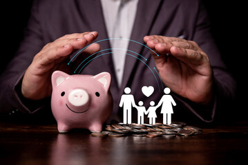 Wall Mural - businessman hand protect on the piggybank and family icon, donation, saving, charity, family finance plan concept, fundraising, superannuation, financial crisis concept