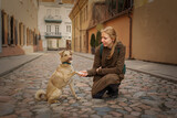 Fototapeta Konie - Beautiful blonde girl with dog in the city