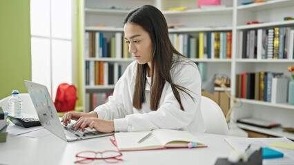 Wall Mural - Young beautiful hispanic woman student using laptop studying at university classroom