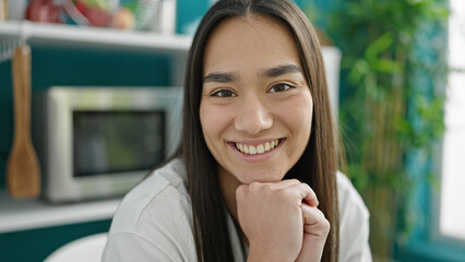 Poster - Young beautiful hispanic woman smiling confident sitting on sofa at dinning room