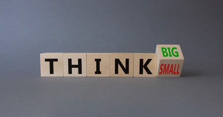 Think Big vs Small symbol. Wooden cubes with words Think Small and Think Big. Beautiful grey background. Business and Think concept. Copy space