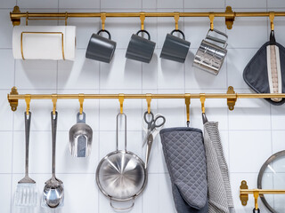 Group of hanging kitchenware and tableware accessories display on the wall in the kitchen utensil store.