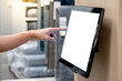 © Summer Paradive - Using interactive touchscreen display in home decoration store. Male customer hand touching on LCD touch screen monitor on the wall for browsing information in furniture design shop.