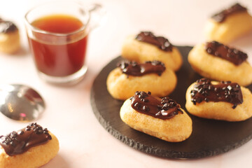 Wall Mural - Traditional French dessert - eclairs with a cup of coffee