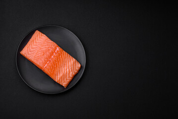 Fresh raw salmon red fish fillet with salt and spices