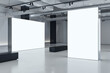 © Who is Danny - Two blank white bright partitions with space for advertising poster or marketing campaign in industrial gallery hall with black benches on concrete floor and grey wall background. 3D rendering, mockup