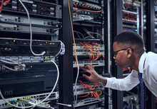 Black Man, IT Technician And Server Room For Cyber Security, Data Or Network Storage Inspection. African Male Person Or Networking Administrator Checking System, Cables Or Installation At Datacenter