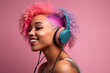 © Margo_Alexa - a happy african american young woman with bright hair in headphones on a pink background listens to music.