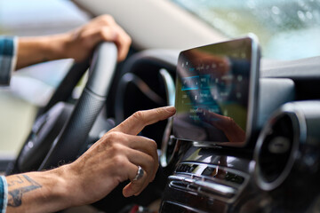 older man sitting in camper van using gps navigation map system digital device. smiling mature activ
