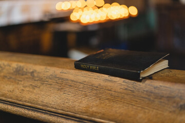 Wall Mural - the Holy Bible in temple. Concept for faith, spirituality and religion. Peace, hope, dreams concept. Bible in an ancient Catholic temple.