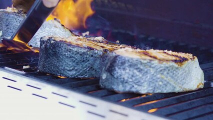 Wall Mural - Grilling salmon steaks on an outdoor gas grill.