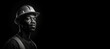 © JoelMasson - Black and white photorealistic studio portrait of a construction worker with hard hat on black background. Generative AI illustration