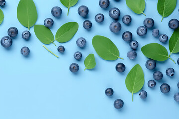 Fresh juicy blueberries with green leaves on blue background. blueberry background