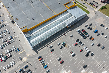 Wall Mural - aerial view of shopping mall parking lot with cars standing on parking lot place.