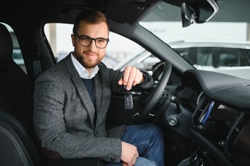 Wall Mural - Handsome businessman driving car before buying