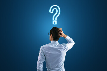 back view to a thoughtful businessman and a question mark on his head on a dark blue background, sea