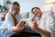 © Westend61 - Mother and pregnant daughter holding baby socks sitting at home
