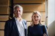 © Westend61 - Senior businessman with colleague in front of stacked wood in factory