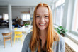 © Westend61 - Young happy redhead businesswoman at office