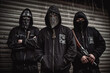 Criminal gangs. Group of criminal people waring black hoodies and masks. Violence and criminal concept. Generative AI