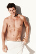 © Anton R/peopleimages.com - Muscle, body and sexy portrait of a man in a towel while happy, handsome and clean. Strong, fitness and young male model posing shirtless with smile, beauty and motivation or inspiration after shower