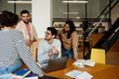 © Drobot Dean - Group of cheerful students having discussion while studying in college library