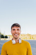 © Dani D.G - Happy handsome young man. Portrait of a cheerful person standing outdoors and smiling at the camera.