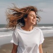 Banner mockup with a beautiful young woman in a white t-shirt with flying hair on the beach. Generative AI.