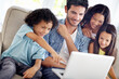 © N Katie/peopleimages.com - Laptop, watch and happy family father, children or people point at online shopping choice, social media video or meme. Happiness, love and group of kids with dad streaming movie in home living room