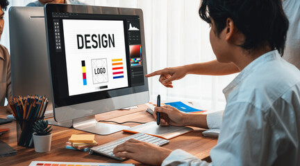 Aufkleber - Graphic designer work on computer laptop and with graphic drawing pen while brainstorming unique design with professional graphic team in modern digital studio workplace. Panorama shot. Scrutinize