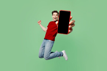 full body young man wear red t-shirt casual clothes jump high hold in hand use close up mobile cell 
