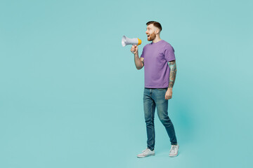 Wall Mural - Full body fun young man he wears purple t-shirt hold in hand megaphone scream announces discounts sale Hurry up isolated on plain pastel light blue cyan background studio portrait. Lifestyle concept.