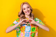© deagreez - Photo of adorable cute lady raise hands showing heart gesture celebrating valentine day isolated yellow color background