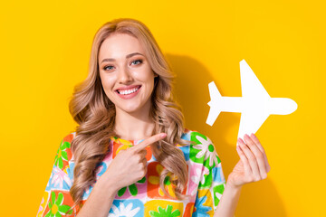 Sticker - Photo of cute attractive lady direct finger paper airplane choose airline vacation wear floral shirt isolated yellow color background